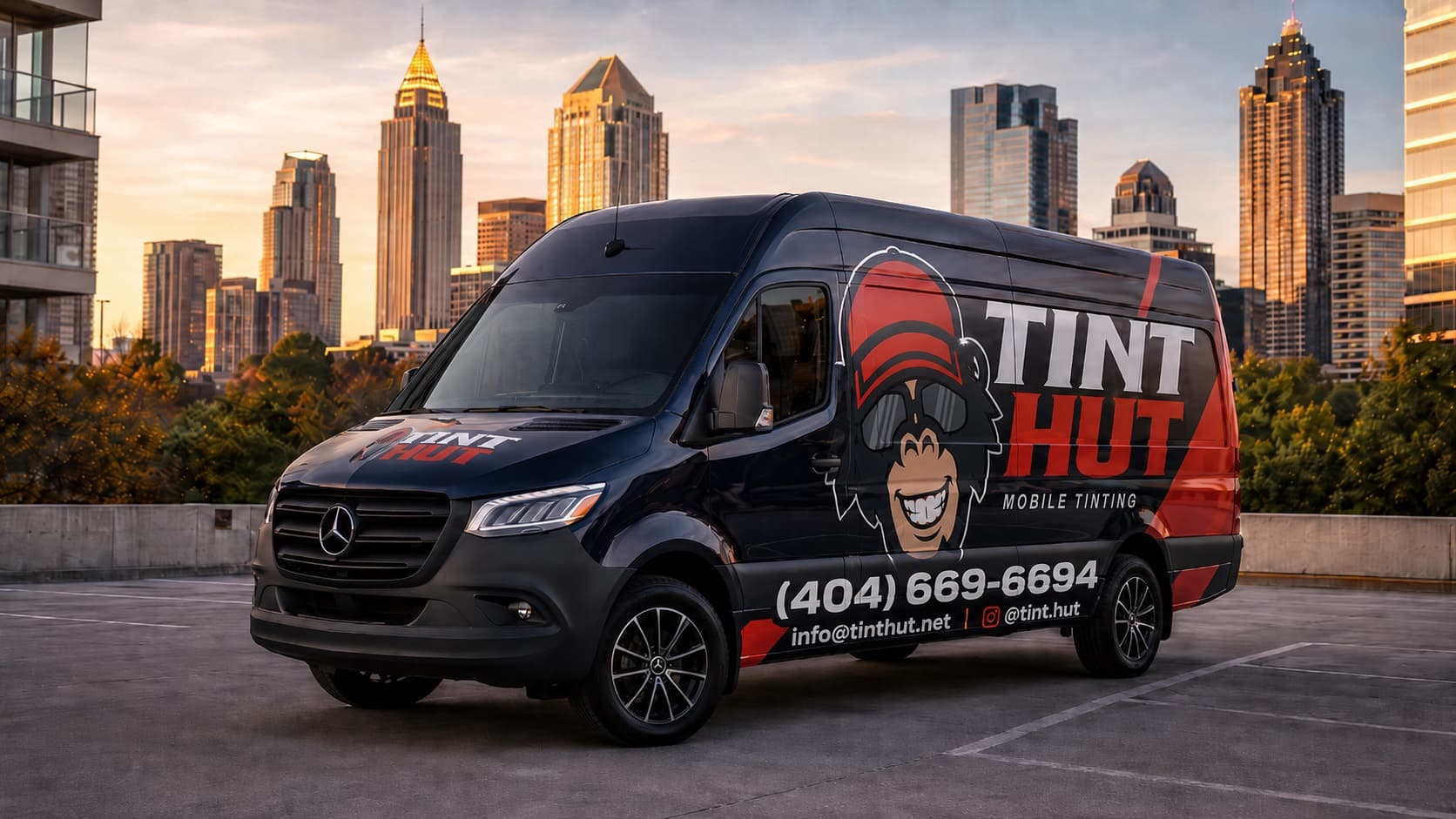 The TintHut mobile tinting van in front of the Atlanta skyline